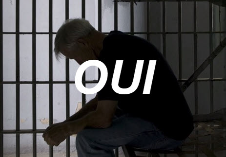 A person sitting in a jail cell AI-generated content may be incorrect.